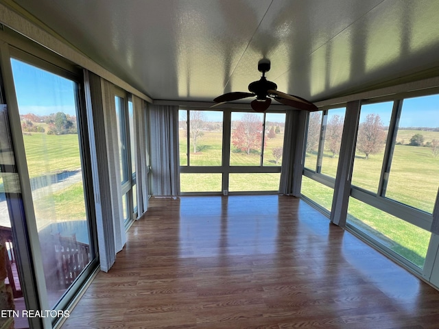 unfurnished sunroom featuring vaulted ceiling and ceiling fan