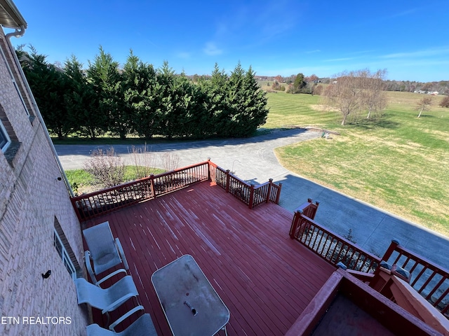 wooden terrace featuring a lawn