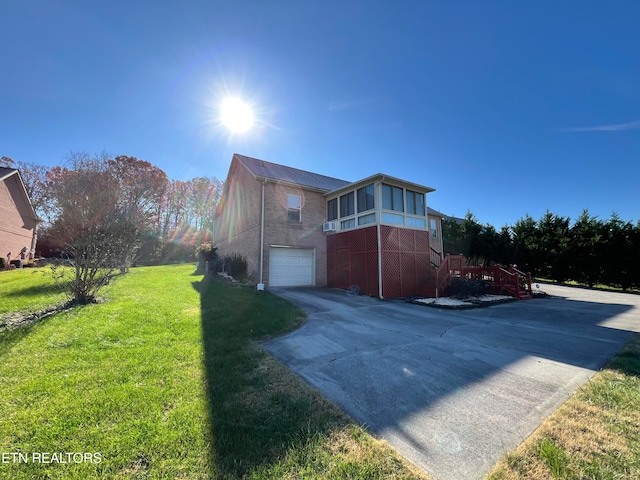 view of side of property featuring a lawn and a garage