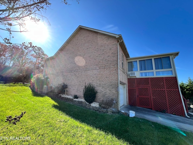 view of property exterior with a yard and a garage