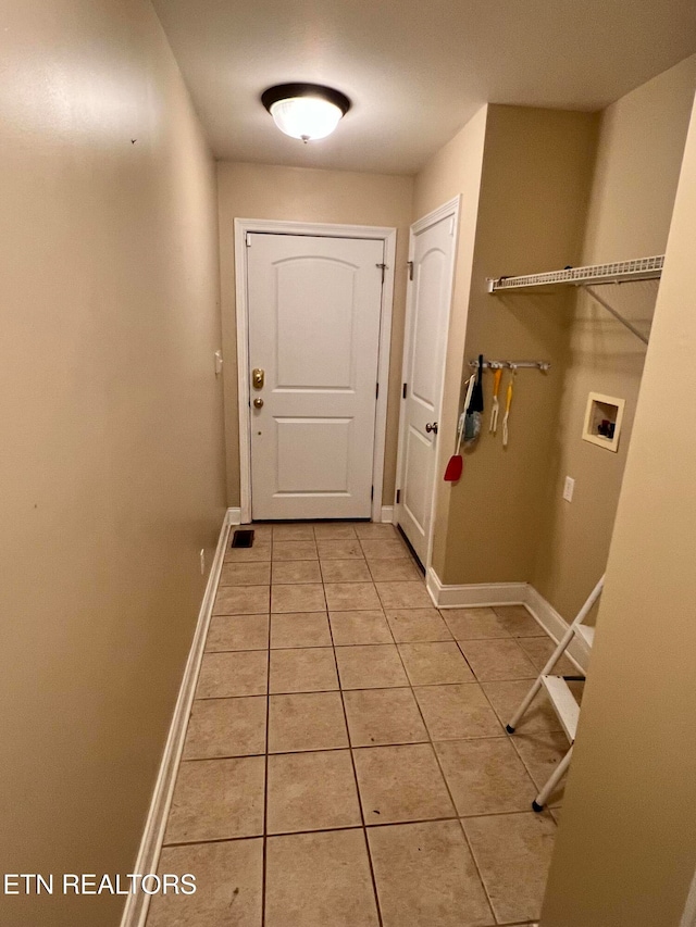 doorway to outside featuring light tile patterned floors