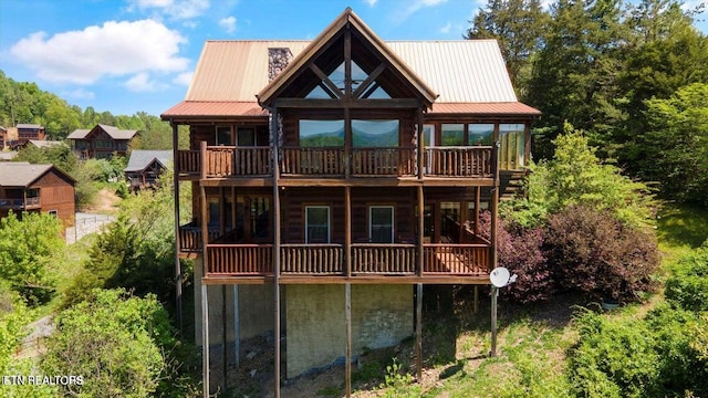 rear view of property featuring a wooden deck