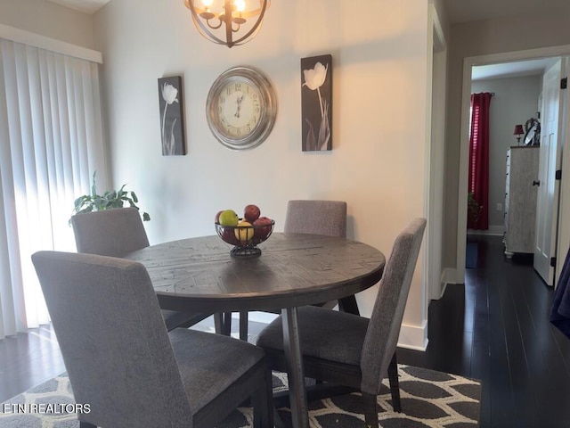 dining room featuring a chandelier and dark wood-type flooring