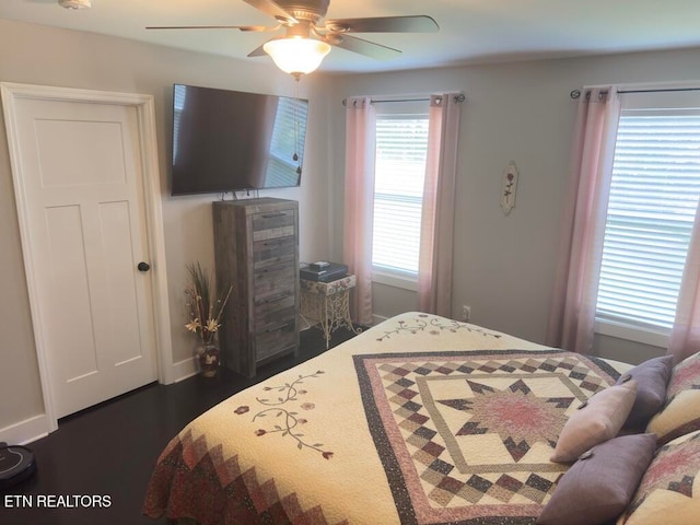 bedroom with ceiling fan and dark wood-type flooring