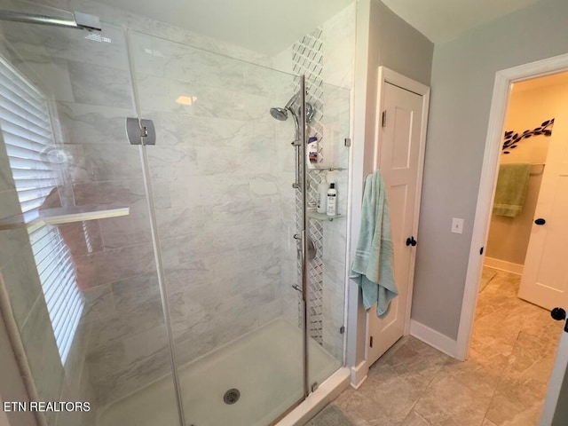 bathroom featuring a shower with door