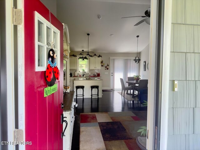 interior space featuring ceiling fan and dark wood-type flooring