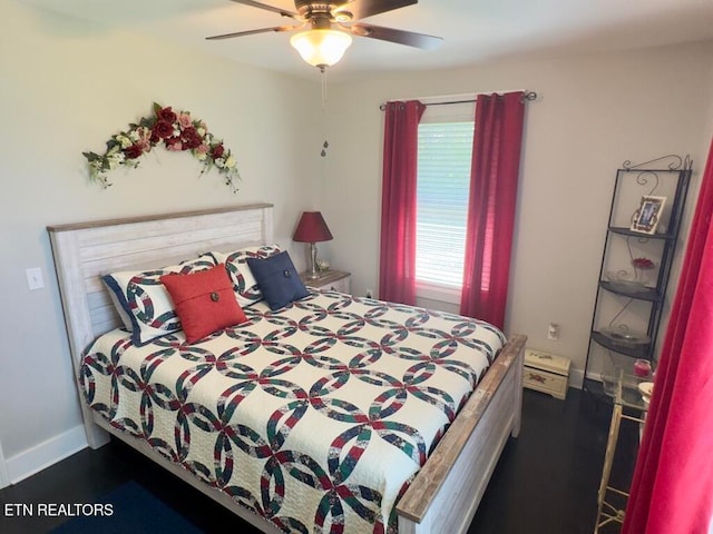 bedroom featuring dark hardwood / wood-style flooring and ceiling fan