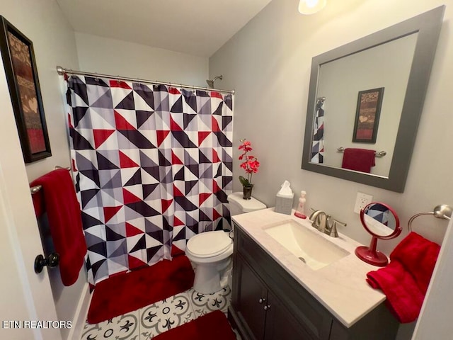 bathroom featuring tile patterned flooring, vanity, and toilet