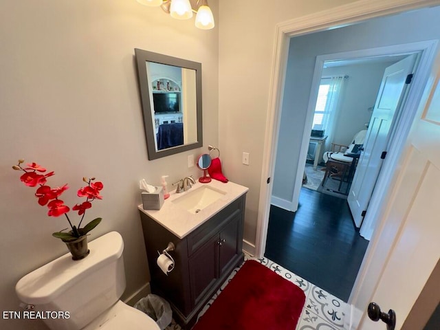 bathroom featuring hardwood / wood-style floors, vanity, and toilet