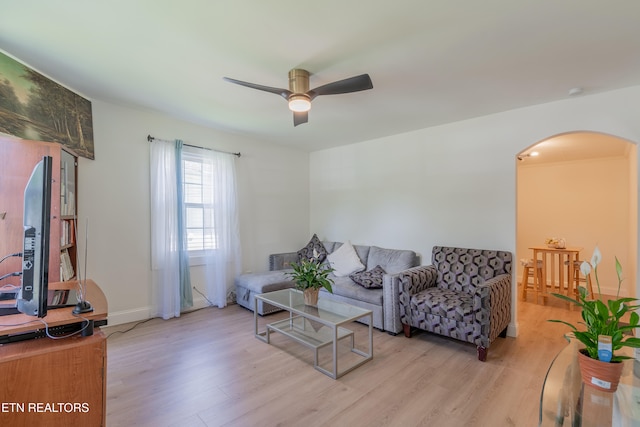 living room featuring ceiling fan and light hardwood / wood-style flooring