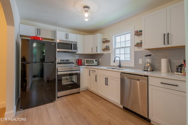 kitchen with white cabinetry, sink, and appliances with stainless steel finishes