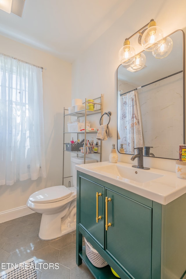 bathroom with tile patterned flooring, vanity, a shower with shower curtain, and toilet