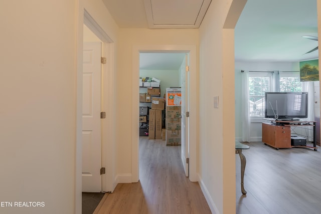 hallway with light hardwood / wood-style flooring