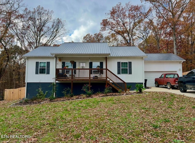 ranch-style house featuring a front yard, a porch, and a garage