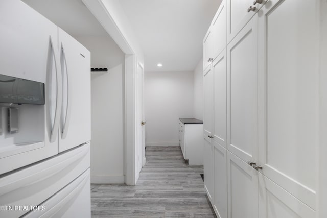 corridor with light hardwood / wood-style flooring