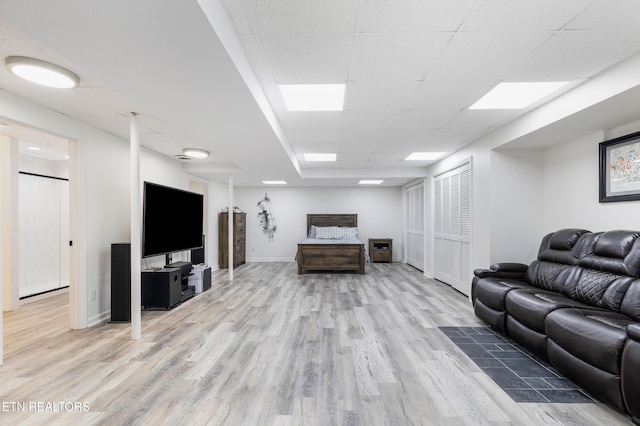 living room featuring hardwood / wood-style floors and a drop ceiling