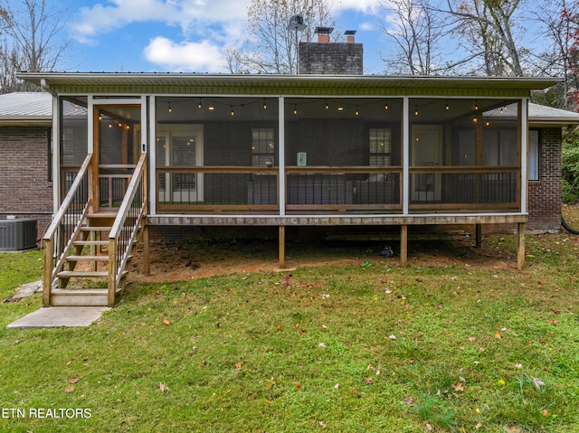 exterior space with a front lawn, central AC, and a sunroom