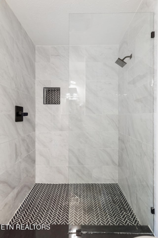 bathroom with tiled shower