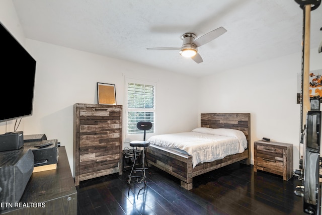 bedroom with ceiling fan and dark hardwood / wood-style flooring