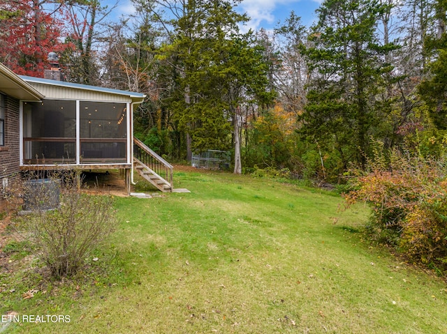 view of yard featuring a sunroom