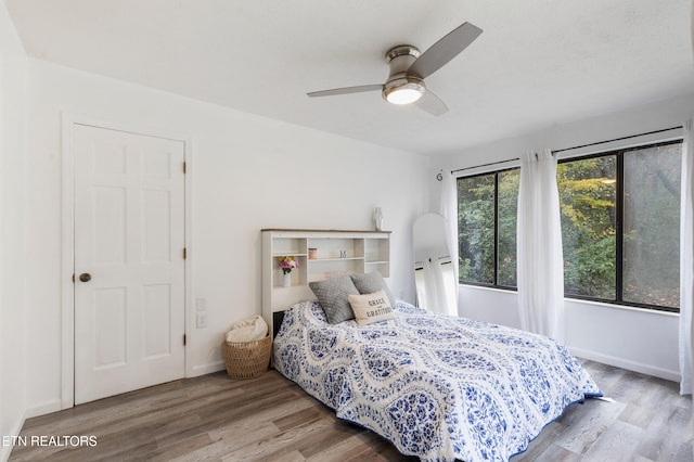 bedroom with light hardwood / wood-style floors and ceiling fan