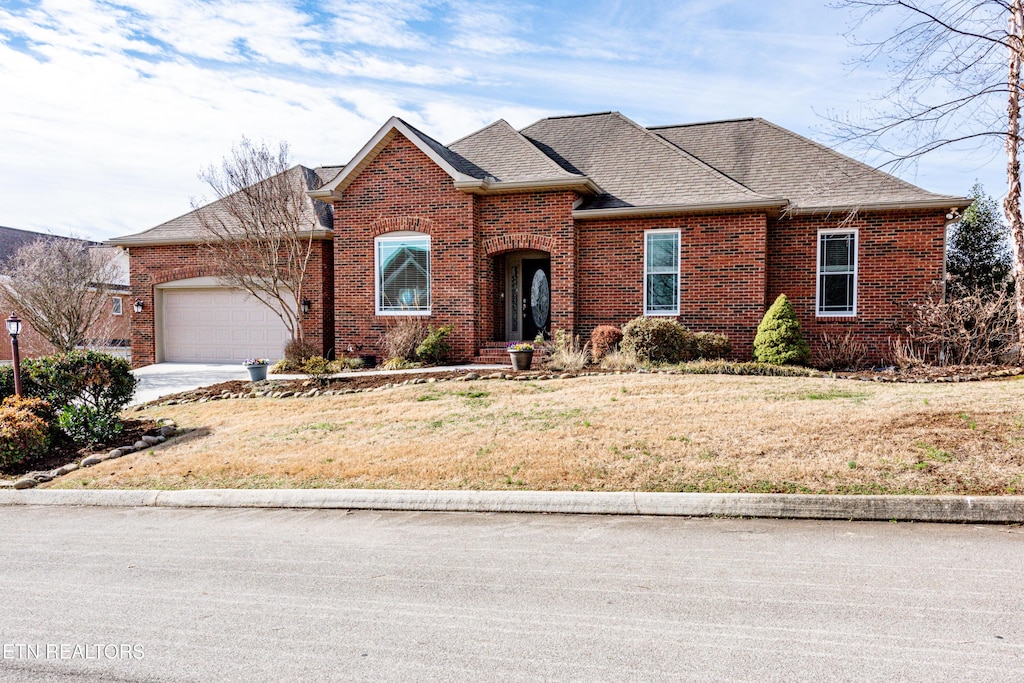 front facade with a garage and a front yard