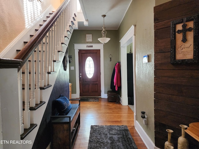 entryway featuring crown molding and wood-type flooring