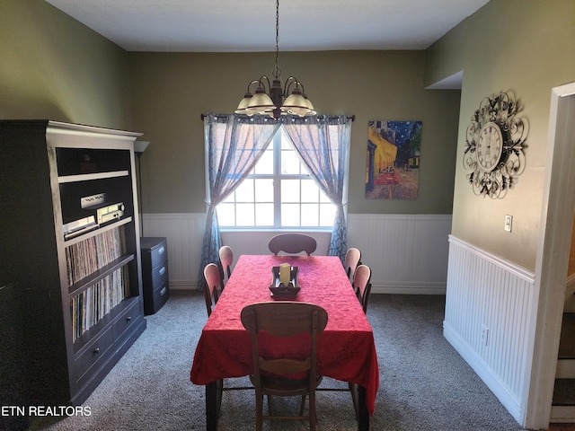 carpeted dining space featuring an inviting chandelier