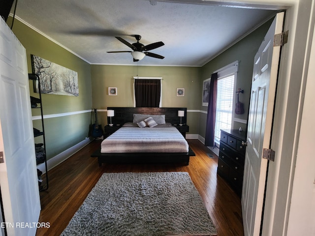 bedroom featuring ceiling fan, dark hardwood / wood-style flooring, and crown molding