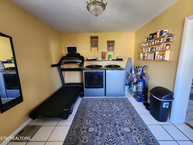 laundry room featuring washer and clothes dryer and light tile patterned floors