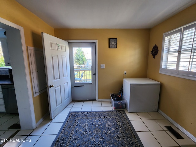 washroom with light tile patterned floors and a wealth of natural light