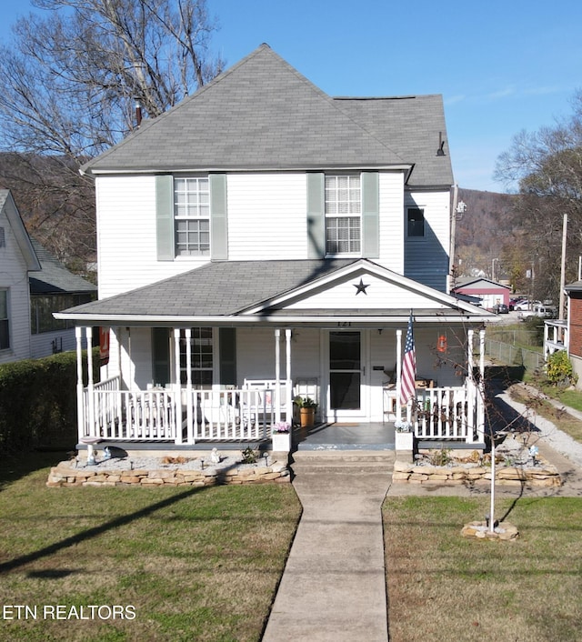 country-style home with a front yard