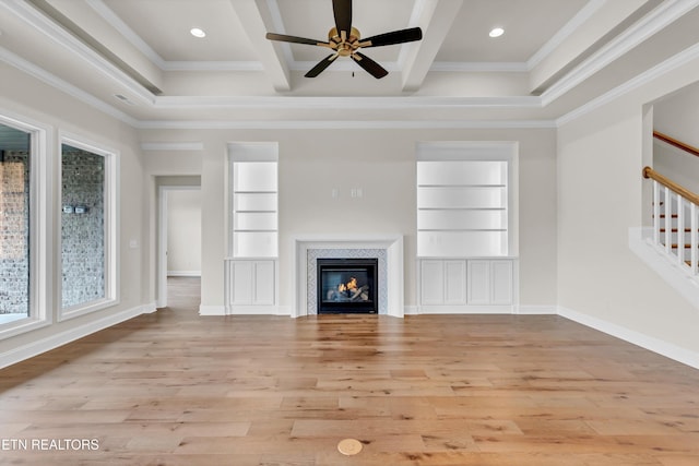 unfurnished living room with beam ceiling, built in features, and ornamental molding