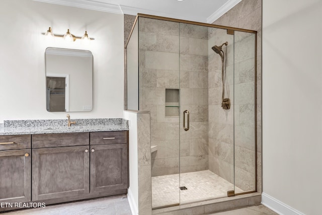 bathroom with tile patterned floors, vanity, an enclosed shower, and ornamental molding