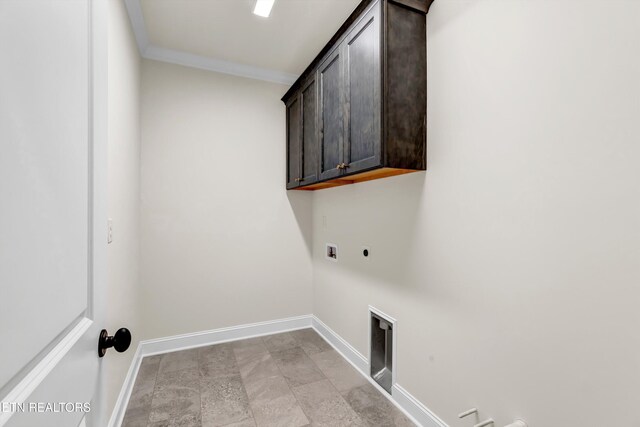 clothes washing area with electric dryer hookup, crown molding, cabinets, and washer hookup