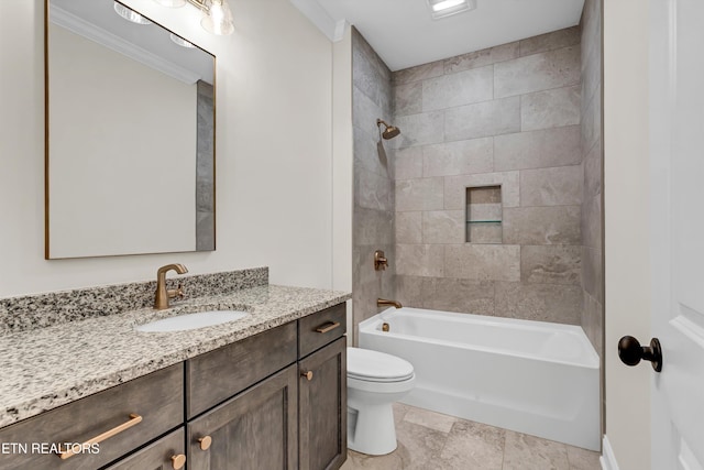 full bathroom featuring crown molding, toilet, vanity, and tiled shower / bath