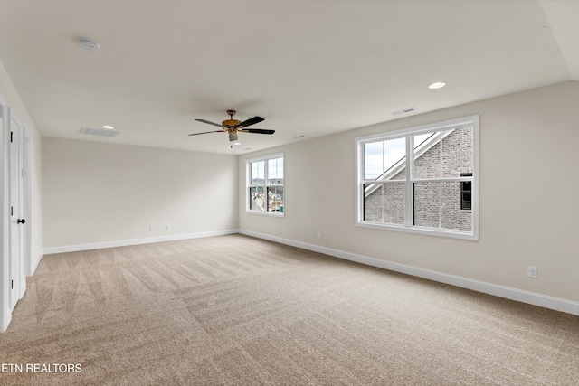 carpeted spare room with ceiling fan