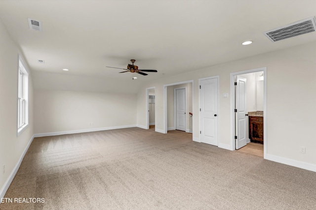 spare room featuring ceiling fan and light colored carpet