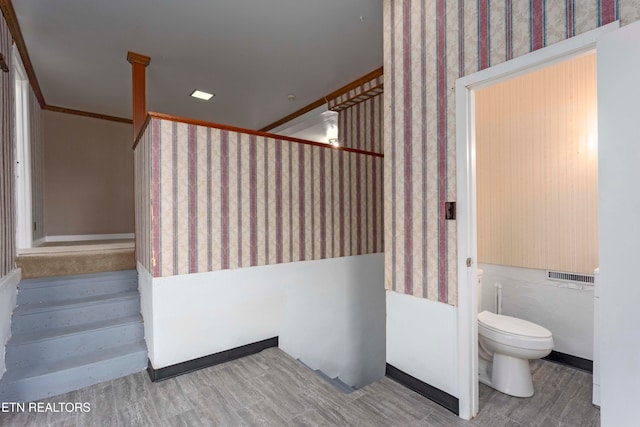 staircase featuring hardwood / wood-style flooring and ornamental molding