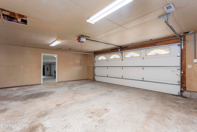 garage featuring a garage door opener and independent washer and dryer