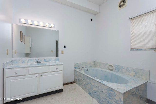 bathroom with vanity and tiled bath