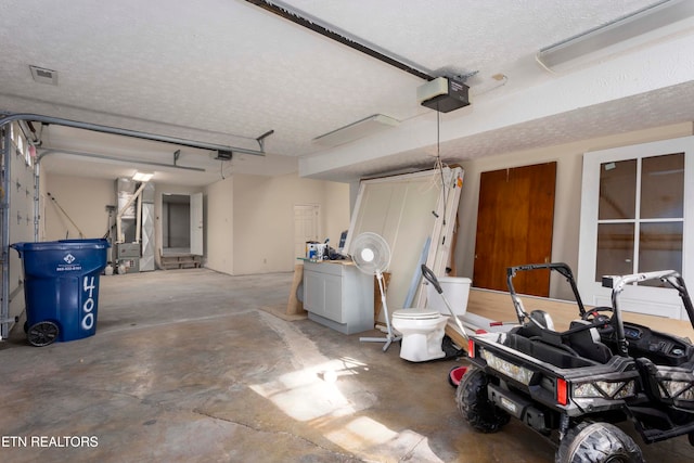 garage with a garage door opener and heating unit