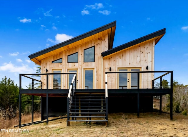 rear view of house with a deck and stairs