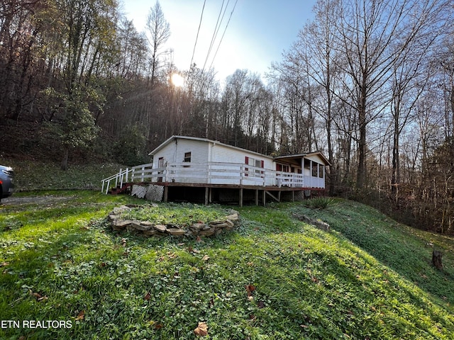 rear view of property featuring a deck