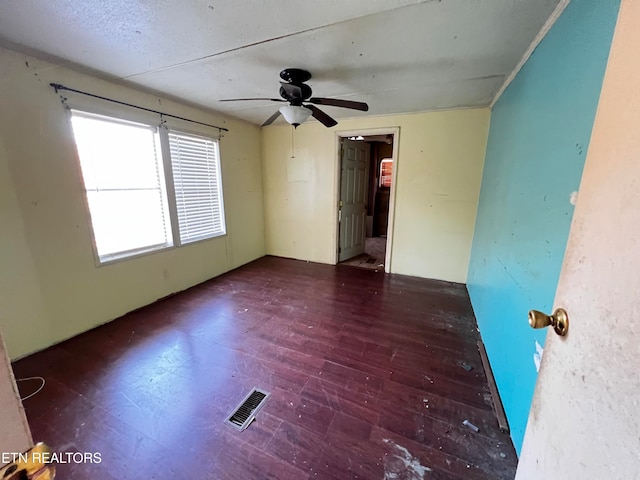 unfurnished room featuring dark hardwood / wood-style floors and ceiling fan