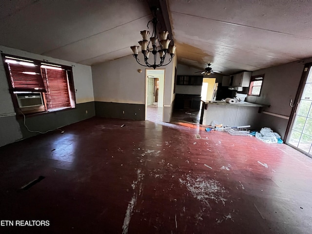 interior space with ceiling fan with notable chandelier, vaulted ceiling, concrete floors, and cooling unit