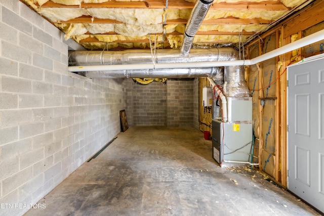 basement featuring heating unit and water heater