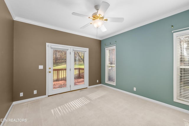 carpeted empty room with ceiling fan and ornamental molding