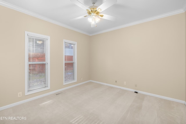 spare room with ceiling fan, light colored carpet, and ornamental molding