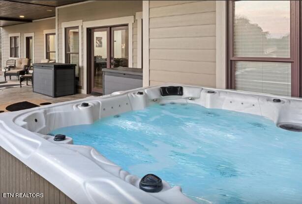 exterior space featuring washer / clothes dryer and a hot tub